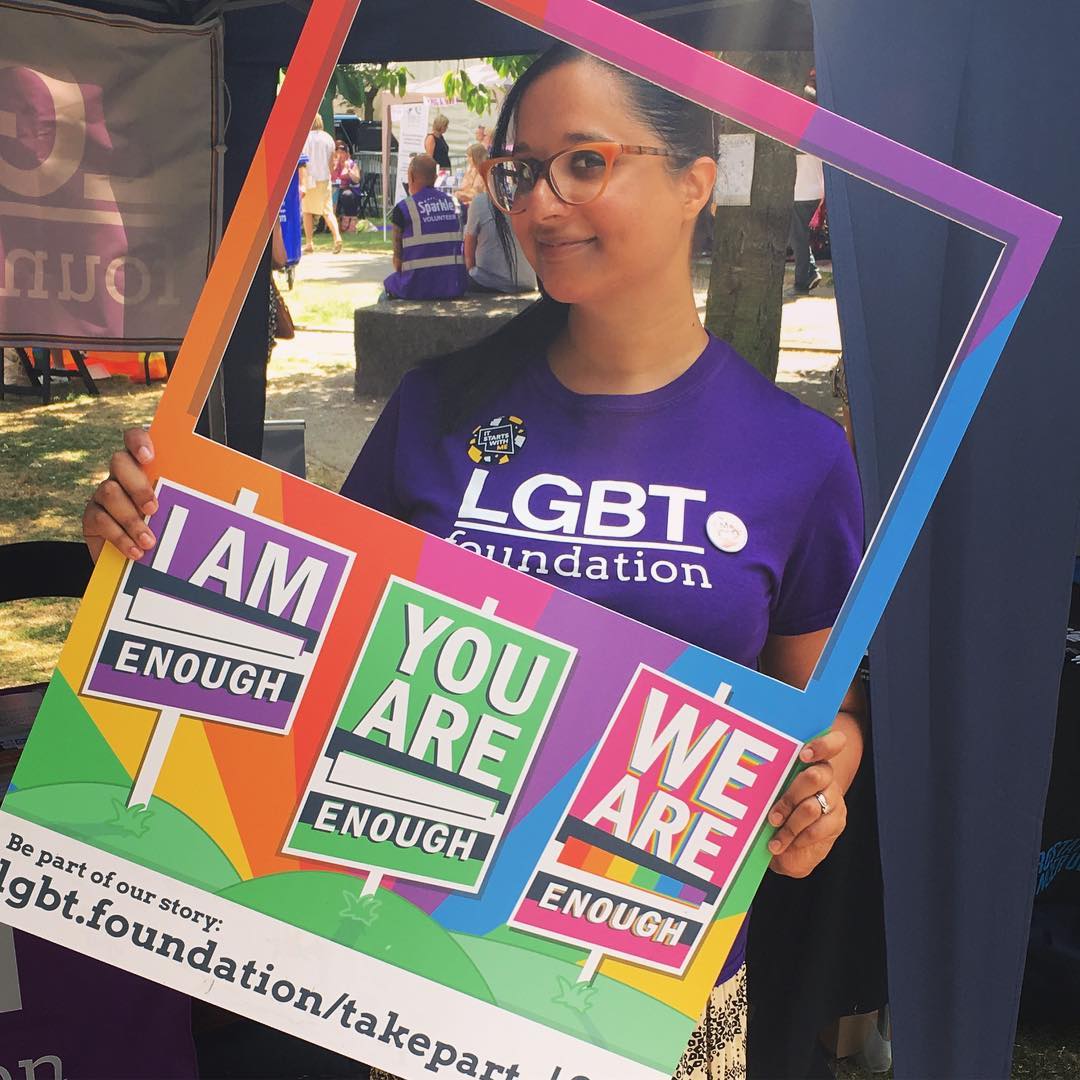 A person posing with the picture frame at an event